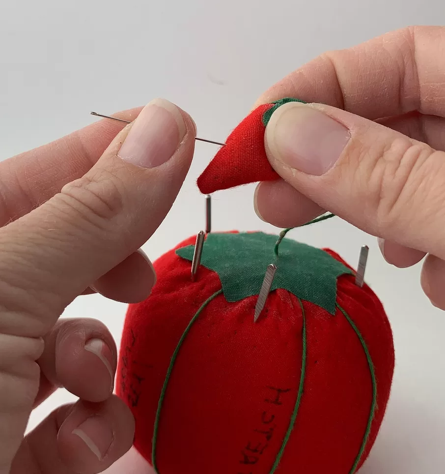 Sharpening needles with an emery board