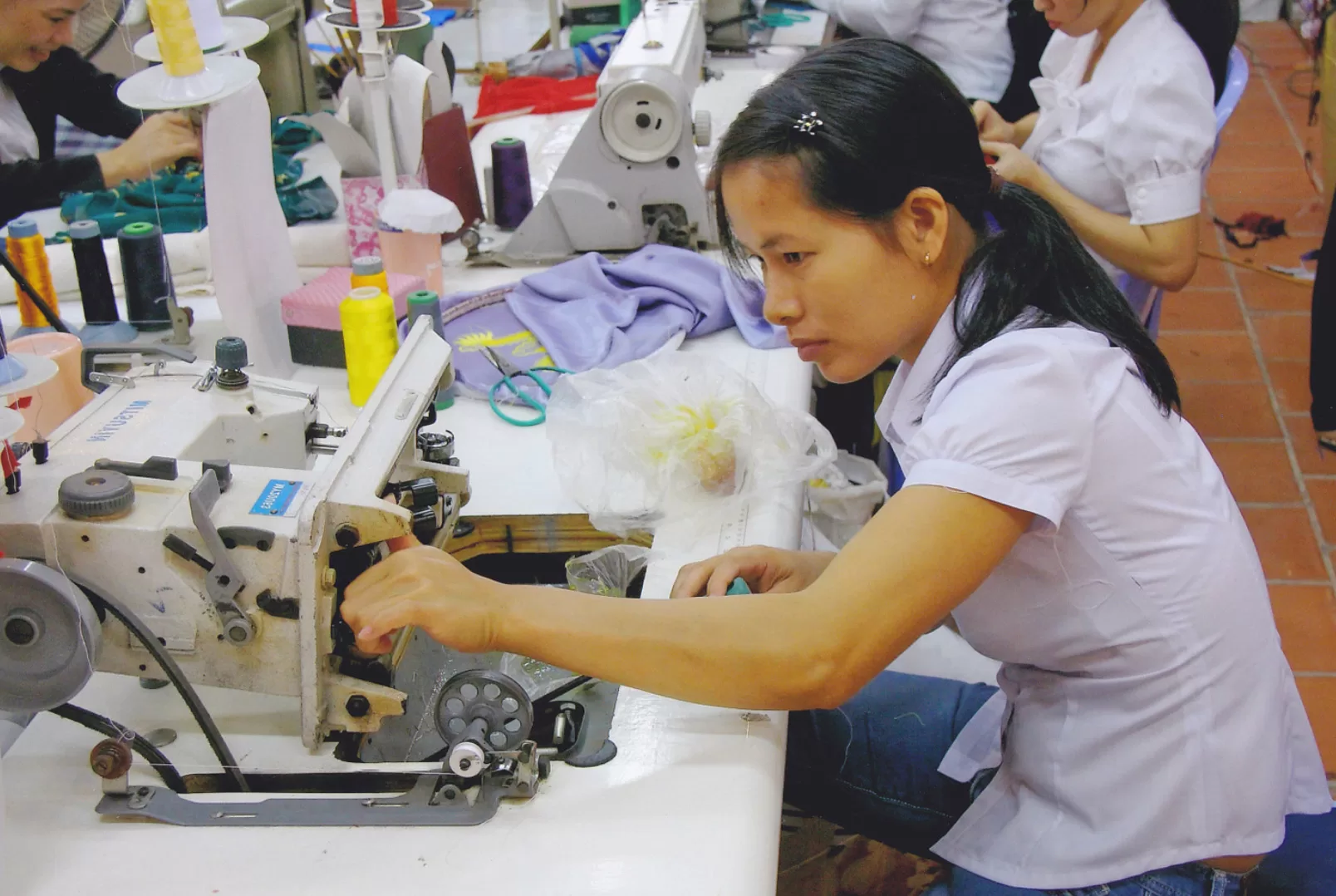 woman is checking her sewing machine